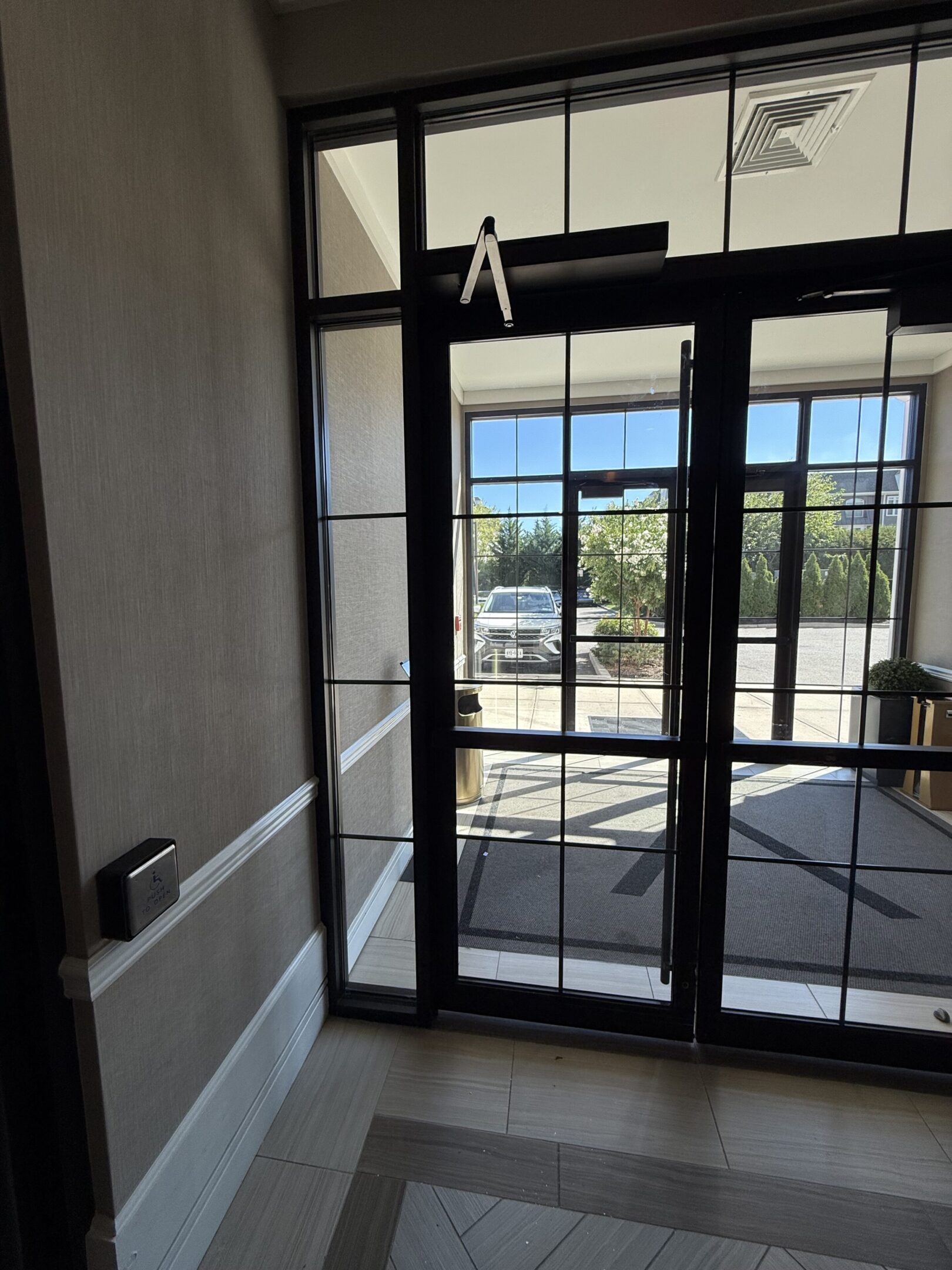 Glass doors leading outside to parking area.