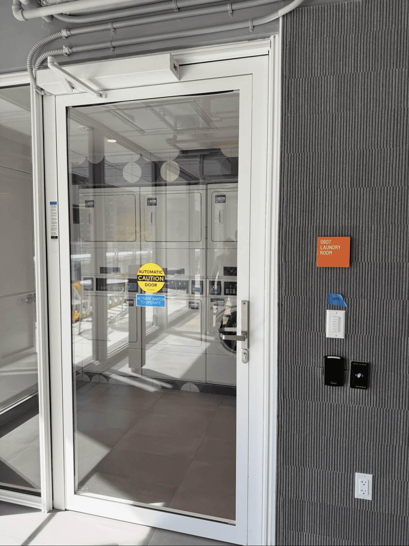 Glass door with security access panel.