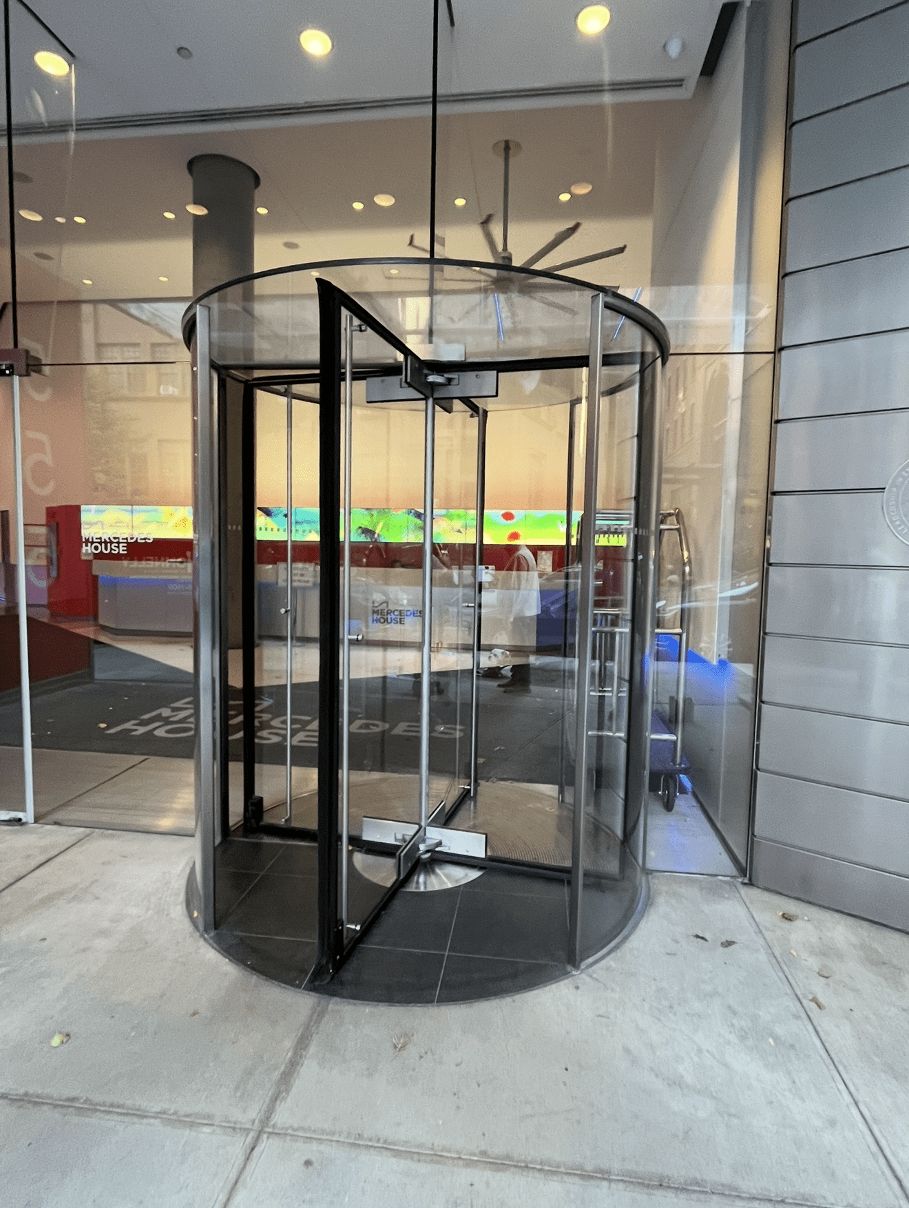 Glass revolving door at building entrance.