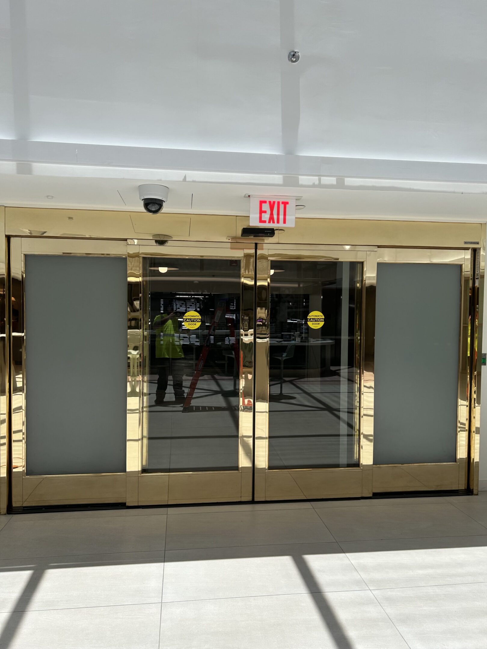 Glass doors with exit sign above.